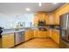Spacious kitchen with stainless steel appliances, ample counter space, and natural lighting at 2484 Mossy Branch Dr, Snellville, GA 30078