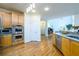 Bright kitchen showcasing stainless steel appliances and views to an open floor plan at 2484 Mossy Branch Dr, Snellville, GA 30078