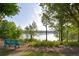 Picturesque lake view from a bench surrounded by lush greenery at 2484 Mossy Branch Dr, Snellville, GA 30078