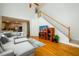 Living room featuring hardwood floors, stairs, and a comfortable couch at 2484 Mossy Branch Dr, Snellville, GA 30078
