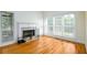 Living room featuring a fireplace, hardwood floors and bright natural light at 2484 Mossy Branch Dr, Snellville, GA 30078