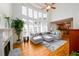 Bright living room with fireplace, large windows, and view to the kitchen at 2484 Mossy Branch Dr, Snellville, GA 30078