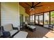 The cozy screened porch is furnished with comfortable seating and access to the outdoor deck and backyard at 2484 Mossy Branch Dr, Snellville, GA 30078