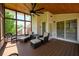 Relaxing screened porch offers ceiling fan, furniture, and natural light, creating an inviting outdoor space at 2484 Mossy Branch Dr, Snellville, GA 30078
