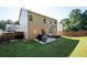 Large backyard with a patio, grilling area, plenty of seating, and a wooden fence at 3537 Edenridge Ct, Buford, GA 30519