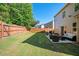 A long, plush green backyard with a patio seating area surrounded by a wooden fence at 3537 Edenridge Ct, Buford, GA 30519