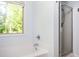 Bright bathroom with a tub, separate shower, and a window with a green tree view at 3537 Edenridge Ct, Buford, GA 30519