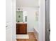 Bathroom with wood cabinets, a white rug, and natural light coming through the mirror at 3537 Edenridge Ct, Buford, GA 30519
