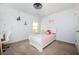 Charming bedroom with a cute polka-dot accent wall, desk, and white-framed twin bed at 3537 Edenridge Ct, Buford, GA 30519