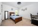 This bedroom features neutral carpet, a window, and a dark wood bedframe at 3537 Edenridge Ct, Buford, GA 30519
