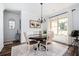 Dining room featuring a dark wood table, light blue walls, and natural light from the window at 3537 Edenridge Ct, Buford, GA 30519