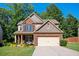 Charming two-story home with brick and siding, a well-manicured lawn, and an attached two-car garage at 3537 Edenridge Ct, Buford, GA 30519