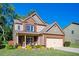 Charming two-story home with brick and siding, a well-manicured lawn, and an attached two-car garage at 3537 Edenridge Ct, Buford, GA 30519