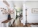 Bright foyer with hardwood floors, white wainscoting, and a staircase leading to the second floor at 3537 Edenridge Ct, Buford, GA 30519