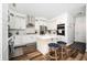 Modern kitchen with stainless steel appliances, white cabinets, island and counter seating at 3537 Edenridge Ct, Buford, GA 30519