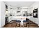 Modern kitchen with stainless steel appliances, white cabinets, and center island seating at 3537 Edenridge Ct, Buford, GA 30519