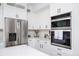 Modern kitchen with stainless steel appliances, white cabinetry, and built in wall ovens at 3537 Edenridge Ct, Buford, GA 30519