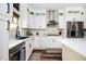 Bright kitchen features white cabinets, stainless steel appliances, and sleek countertops at 3537 Edenridge Ct, Buford, GA 30519