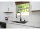 Bright kitchen features white cabinets, sleek countertops, and a modern sink and faucet at 3537 Edenridge Ct, Buford, GA 30519