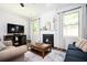 Cozy living room with fireplace, large windows, and comfortable seating at 3537 Edenridge Ct, Buford, GA 30519