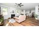 Open-concept living room with hardwood floors, a fireplace, and views into the kitchen at 3537 Edenridge Ct, Buford, GA 30519
