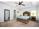 Relaxing main bedroom with tray ceilings, large windows, and a cozy bed at 3537 Edenridge Ct, Buford, GA 30519