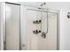 Bright shower stall with white tile, a sliding glass door, and mounted organizers at 3537 Edenridge Ct, Buford, GA 30519