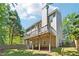 Exterior of the home showcasing the deck, fenced backyard, and mature trees at 5060 Winship Ct, Alpharetta, GA 30009