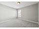 A standard bedroom with neutral gray walls and carpeting and a window with blinds at 5060 Winship Ct, Alpharetta, GA 30009