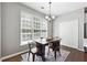 Bright dining room has great natural light with a wooden table and chairs and wood flooring at 5060 Winship Ct, Alpharetta, GA 30009