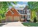 Beautiful two-story home with manicured lawn, brick facade, and two-car garage offers great curb appeal at 5060 Winship Ct, Alpharetta, GA 30009