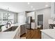 Well-lit kitchen with white cabinets, stainless steel appliances, hardwood floors, and a spacious island with seating at 5060 Winship Ct, Alpharetta, GA 30009