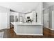 Bright kitchen features white cabinets, stainless steel appliances, and a large island with quartz countertops at 5060 Winship Ct, Alpharetta, GA 30009