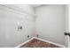 Small laundry room featuring vinyl flooring, utility connections, and wire rack shelving at 5060 Winship Ct, Alpharetta, GA 30009