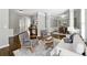 Open-concept living room with hardwood floors, neutral tones, views of the kitchen, and a dining area at 5060 Winship Ct, Alpharetta, GA 30009