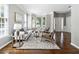 Inviting living room with hardwood floors, neutral walls, large bay window, and comfortable seating arrangement at 5060 Winship Ct, Alpharetta, GA 30009