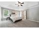 Spacious main bedroom with trey ceilings, plush carpet, and ensuite bathroom at 5060 Winship Ct, Alpharetta, GA 30009