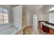 Spacious bathroom features a soaking tub, a shower, and single sink vanity with granite counters at 514 Jadetree Ln, Atlanta, GA 30349