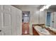 Bathroom view showcasing the vanity and a glimpse into the hardwood-floored hallway at 514 Jadetree Ln, Atlanta, GA 30349