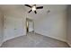 Bedroom featuring closet doors, carpeted floors, and a ceiling fan at 514 Jadetree Ln, Atlanta, GA 30349