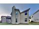 Angled view of a modern two-story home with neutral siding and a unique chimney feature at 514 Jadetree Ln, Atlanta, GA 30349