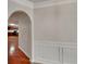 Hallway with hardwood floors and an archway to the kitchen, showcasing the home's layout at 514 Jadetree Ln, Atlanta, GA 30349