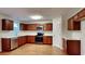 The kitchen features stainless steel appliances, dark wooden cabinets and modern countertops at 514 Jadetree Ln, Atlanta, GA 30349