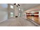 Open-concept living room with a fireplace, soaring ceilings, and seamless flow into the adjacent kitchen at 514 Jadetree Ln, Atlanta, GA 30349
