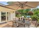 Back patio with outdoor seating area, umbrella, and view of the swimming pool at 5860 Riverwood Dr, Sandy Springs, GA 30328