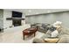 Spacious basement with white brick fireplace, mounted tv, and comfortable seating area at 5860 Riverwood Dr, Sandy Springs, GA 30328