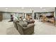 Open basement with neutral carpet, multiple seating areas, and flexible workspace at 5860 Riverwood Dr, Sandy Springs, GA 30328