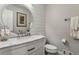 Bathroom with white vanity, marble countertop, round mirror, and shiplap walls at 5860 Riverwood Dr, Sandy Springs, GA 30328