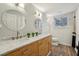 Bright bathroom featuring double vanity with marble countertop and wood-look flooring at 5860 Riverwood Dr, Sandy Springs, GA 30328