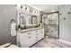 Elegant bathroom with double vanity, a large mirror, and a walk-in shower at 5860 Riverwood Dr, Sandy Springs, GA 30328